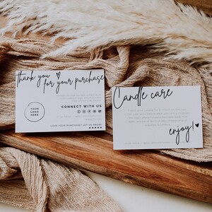 May include: Two white cards with black text on a wooden surface. The first card says "Thank you for your purchase" and has a heart symbol. The second card says "Candle care" and includes instructions for burning candles. Both cards have a logo and social media information.