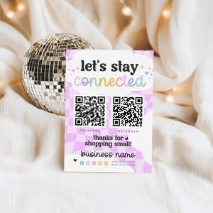 May include: A business card with the text "let's stay connected" in a colorful design. It includes QR codes for Facebook and Instagram, and the text "thanks for shopping small!" and "business name". A disco ball is in the background.