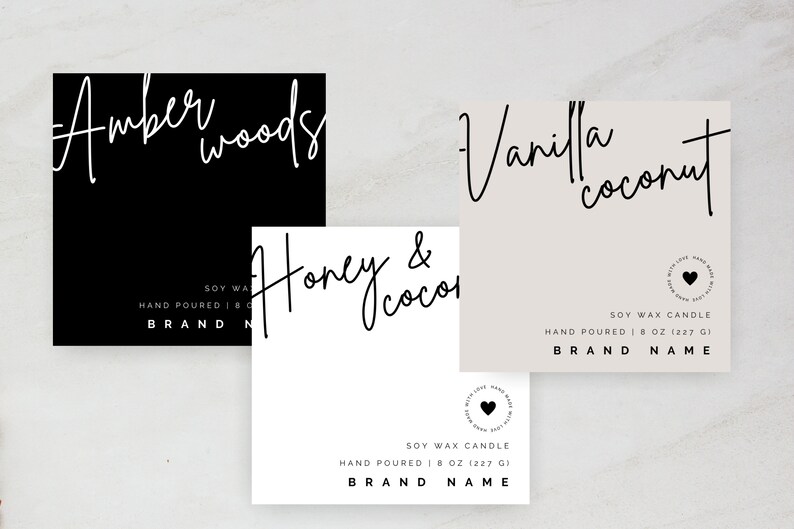 May include: Three square labels for soy wax candles. The labels are white with black text and a black heart logo. The scents are Amber Woods, Honey & Coco, and Vanilla Coconut. Each label says "Soy Wax Candle" and "Hand Poured | 8 oz (227 g) | BRAND NAME".