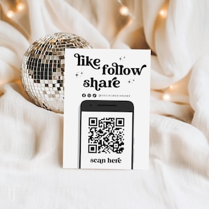 May include: A white card with the words "like follow share" in a stylish font, along with social media icons and a QR code. The words "scan here" are at the bottom. A disco ball is in the background.