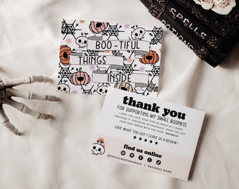May include: Two rectangular cards with Halloween themes. One card features a pattern of skulls, pumpkins, and spiderwebs with a banner reading BOO-TIFUL THINGS INSIDE. The other card says thank you for supporting my small business.