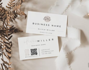 May include: Two white rectangular business cards with black text. The top card displays a circular logo, BUSINESS NAME, OLIVIA MILLER, and WEBSITE.COM. The bottom card features OLIVIA MILLER, BUSINESS NAME, a QR code, social icons, and contact details.