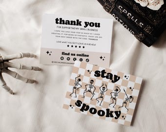 May include: Two rectangular cards with black text and graphics. One card reads thank you for supporting my small business with social media icons. The other card features a beige and white checkerboard pattern with dancing skeletons and the text stay spooky.