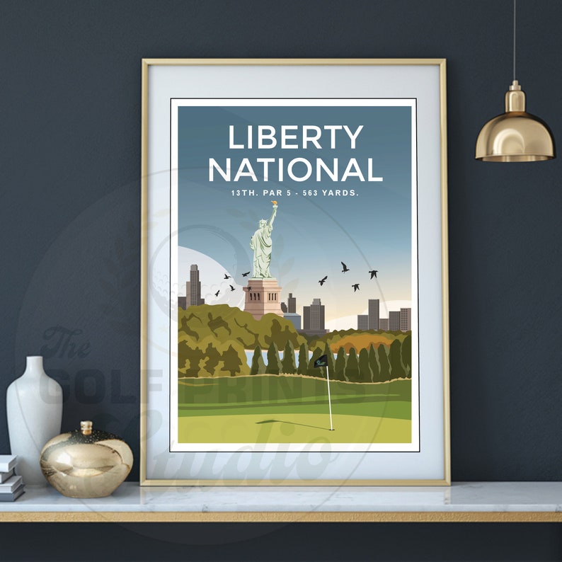 May include: A poster with a blue background featuring a stylized illustration of the Statue of Liberty and a golf course. The text "LIBERTY NATIONAL" is at the top of the poster, and the text "13TH. PAR 5 - 563 YARDS." is below the image.