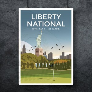 May include: A poster with a blue background and the text "Liberty National" in white. The text "13th. Par 5 - 563 Yards." is below the title. The poster features a green golf course with a flag in the foreground. A statue of the Statue of Liberty is in the background, with a cityscape behind it.