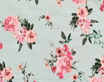 May include: A light blue fabric with a repeating floral pattern. The design features clusters of pink and red flowers with green leaves. The flowers vary in size and style, creating a textured and visually appealing pattern.