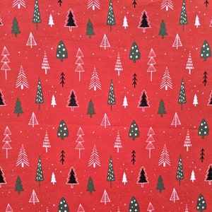 May include: Red fabric with a repeating pattern of Christmas trees in white, black, and green. The trees vary in style, some with dots, others with solid shapes, and some with layered branches. Small white dots are scattered across the background.