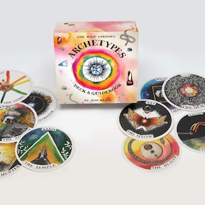May include: A deck of tarot cards with colorful illustrations and the title "Archetypes Deck & Guidebook by Kim Krans" on the box. The cards feature images of the Cosmic, Destroyer, Pit, Hunter, Temple, Mystic, Healer, Gem, Bridge, and more.