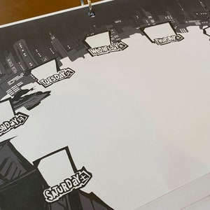 May include: Black and white illustration of a city skyline with each day of the week labelled in a box. The days of the week are Monday, Tuesday, Wednesday, Thursday, Friday, Saturday, and Sunday.