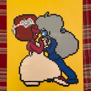 May include: A pixel art wedding scene featuring two characters, one in a white dress and the other in a blue suit. The characters are standing close together, with the woman on the left and the man on the right. The woman has red hair and the man has grey hair. The background is yellow.