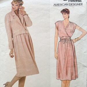 May include: A vintage sewing pattern for a two-piece outfit. The pattern includes a jacket and skirt, both in a light pink colour. The pattern is from American Designer Patterns.