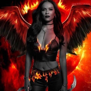 May include: A digital art piece featuring a woman with fiery wings and a black outfit with flame accents. The background is a blend of red and orange hues, with a sun-like shape. The image has a dramatic, fantasy theme.
