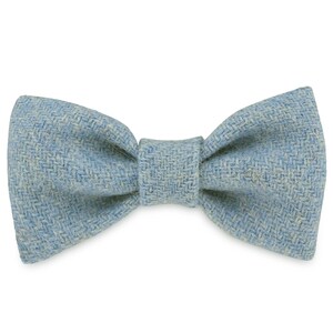May include: A light blue bow tie made of a textured fabric.