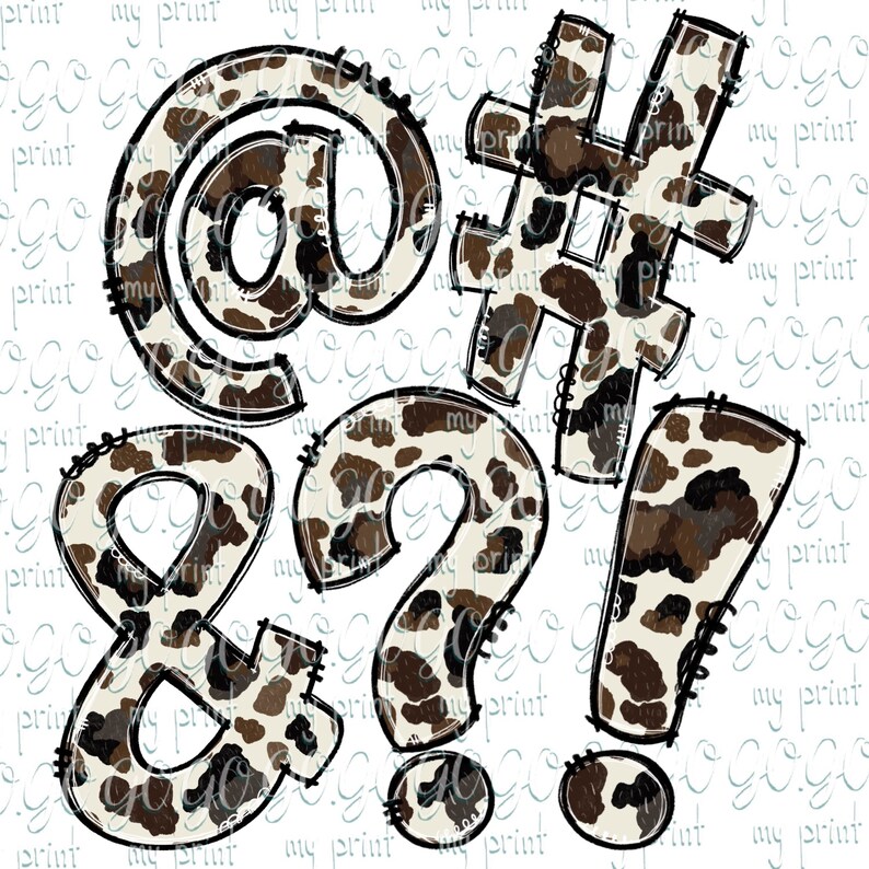 May include: A set of five brown and white cow print symbols: an at sign, a number sign, an ampersand, a question mark, and an exclamation point.