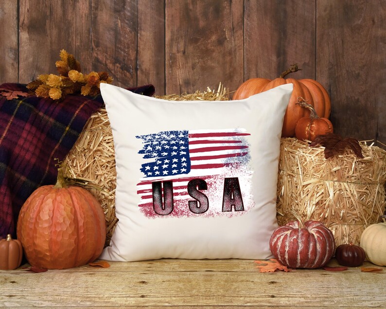 Distressed red white and blue American flag design shown on a white pillow mockup.