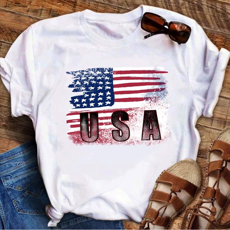 Distressed USA flag design with stars and red white stripes shown on a white T-shirt mockup.