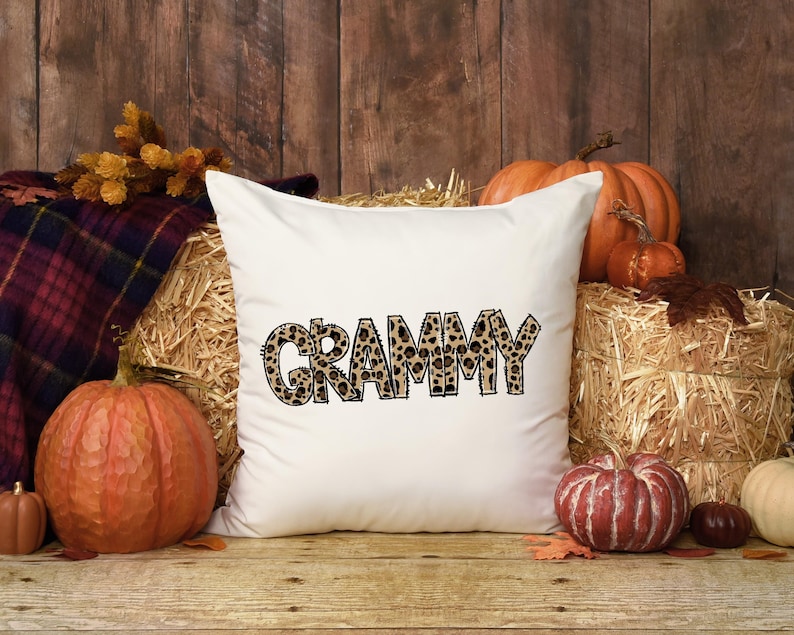 Grammy leopard print lettering displayed on a white pillow in an autumn home decor mockup.