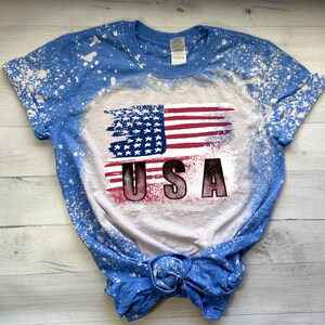 Patriotic USA flag sublimation design displayed on a blue bleached T-shirt mockup.