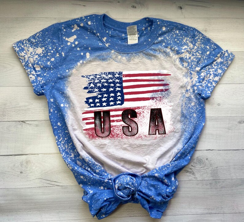 Patriotic USA flag sublimation design displayed on a blue bleached T-shirt mockup.