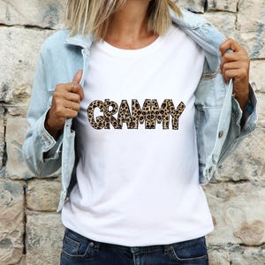 Woman wearing a white shirt featuring the Grammy leopard print hand drawn lettering design.