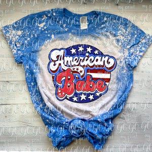 American Babe patriotic retro lettering displayed on a blue and white bleached T-shirt.