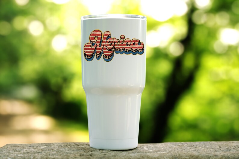 May include: White tumbler with a red, white, and blue "Merica" graphic. The graphic has a distressed look and is in a retro font.