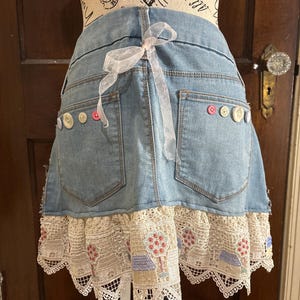 Handmade denim half apron with two pockets and tie back.