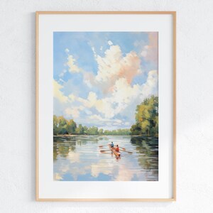May include: A framed art print featuring a serene landscape painting. The artwork depicts a boat with two figures rowing on a calm lake, reflecting the sky and clouds. The sky is a mix of blue, white, and peach hues, with green trees lining the distant shore.