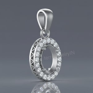 May include: A silver pendant with a halo of small, round, clear gemstones encircling an open center. The pendant has a loop at the top for a chain and a decorative, geometric design on the outer edge. The pendant is reflected in the surface below.