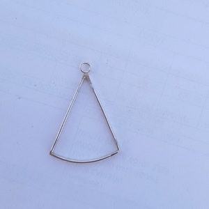 May include: Silver triangle pendant with a loop at the top for attaching a chain or cord.