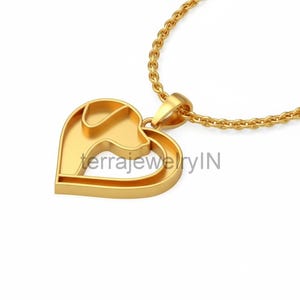 Könnte beinhalten: Eine goldfarbene Halskette mit Anhänger. Der Anhänger hat eine Herzform mit einer Hunde-Silhouette. Die Halskette hat eine zarte Goldkette. Der Text "terrajewelryIN" ist auf dem Anhänger zu sehen.