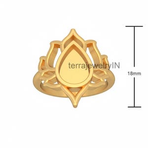 May include: A gold-colored ring with a lotus flower design. The ring features a teardrop-shaped center and measures 18mm in height. The text "terrajewelryIN" is visible on the ring's surface. This ring is a piece of jewelry.