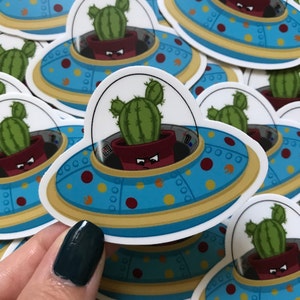 Pegatina de vinilo de nave espacial alienígena de cactus enojado