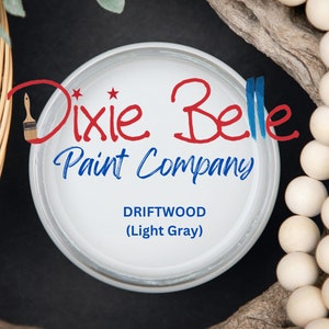 May include: A white paint can with the Dixie Belle Paint Company logo and the text "Driftwood (Light Gray)".