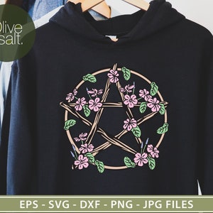 May include: A black hoodie with a pentagram design featuring a circle of twigs with pink and purple flowers. The design is centered on the hoodie.