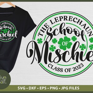 May include: Black t-shirt with a graphic design featuring the text "THE LEPRECHAUN School OF Mischief CLASS OF 2023" in white and green. The design includes shamrocks. The Olive & Salt logo is at the bottom.