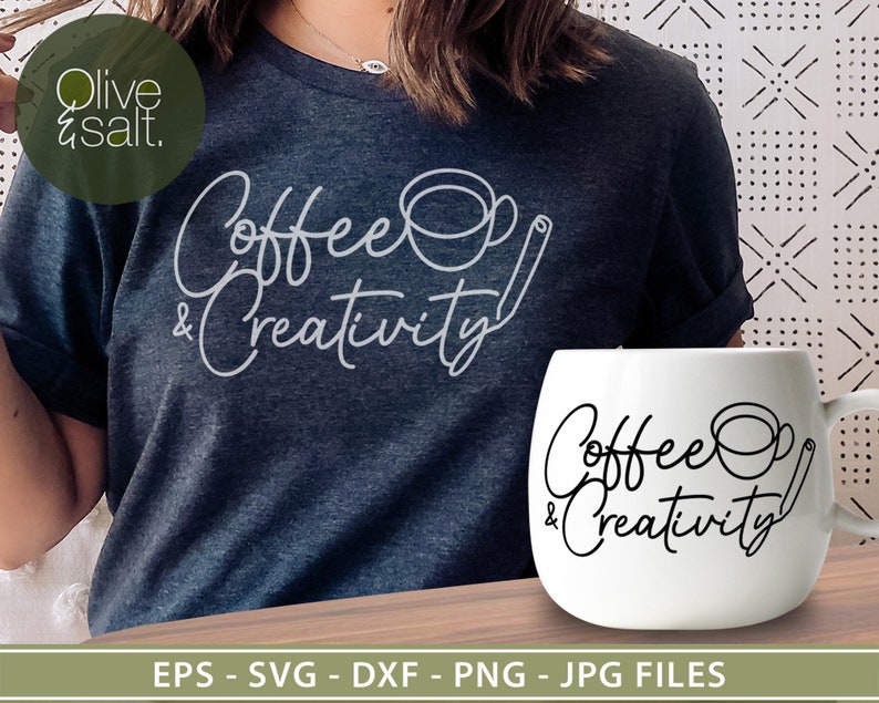 May include: A white ceramic mug with black text that reads "Coffee & Creativity" and a simple line drawing of a coffee cup and a cinnamon stick. The mug is sitting on a wooden table.
