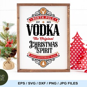 May include: A white sign with a brown wood frame, featuring a vintage-style design with the text "North Pole Vodka The Original Christmas Spirit Triple Distilled by Elves". The sign has a red and gold color scheme and a reindeer illustration.