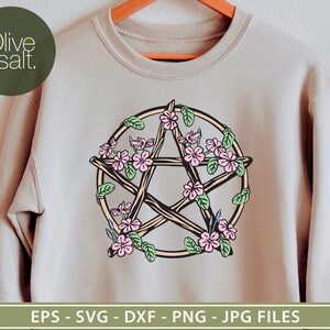 May include: A beige sweatshirt with a pentagram design made of twigs and surrounded by pink flowers. The pentagram is outlined in brown and the flowers have pink and white petals.