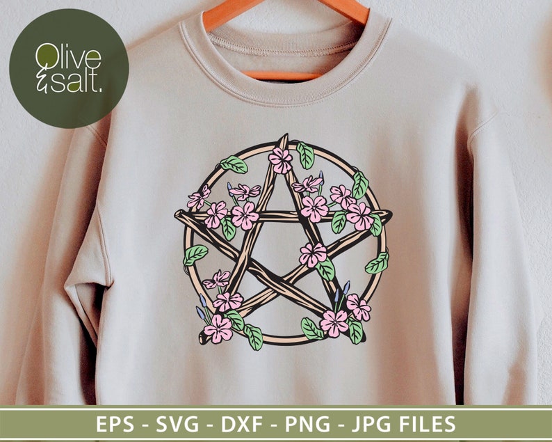 May include: A beige sweatshirt with a pentagram design made of twigs and surrounded by pink flowers. The pentagram is outlined in brown and the flowers have pink and white petals.