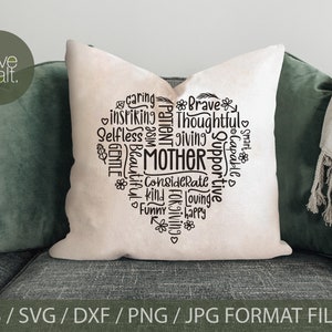 May include: A white pillow with a black heart-shaped design. The heart is filled with words describing a mother, such as "caring", "thoughtful", "supportive", and "loving".