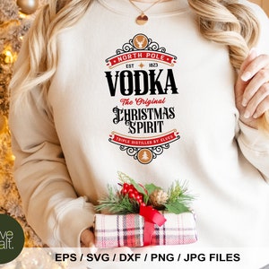 May include: A white sweatshirt with a red and black graphic design that says "North Pole Vodka The Original Christmas Spirit Triple Distilled by Elves".