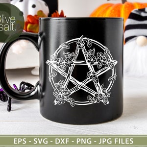 May include: Black ceramic mug with a white pentagram design featuring a floral motif. The pentagram is made of branches with flowers and leaves around it.