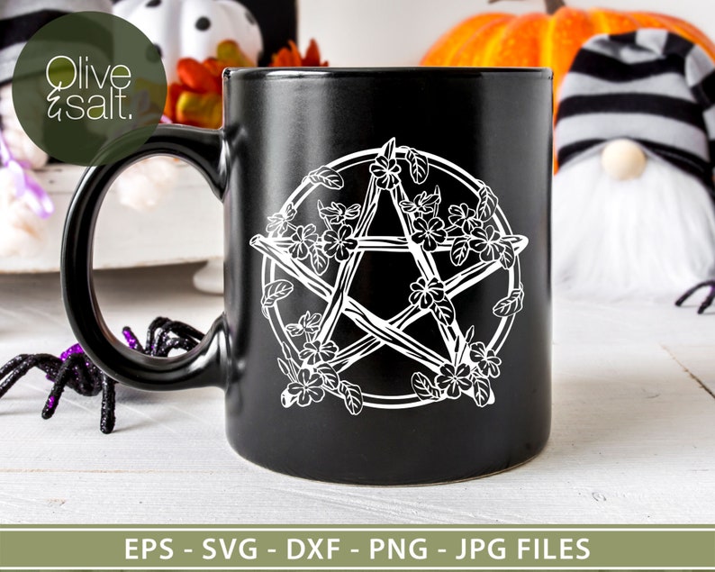 May include: Black ceramic mug with a white pentagram design featuring a floral motif. The pentagram is made of branches with flowers and leaves around it.
