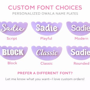 May include: Image showcasing custom font options for personalized name plates. The text "Sadie" is displayed in various fonts: Script, Playful, Modern, Block, Classic, and Rounded. The name plates are lavender with a scalloped edge. Text at the top reads "CUSTOM FONT CHOICES".