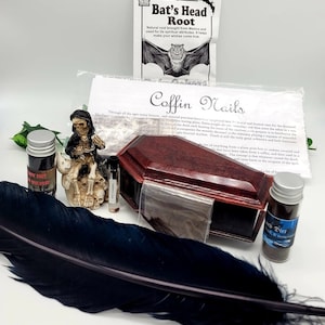 May include: A collection of witchcraft supplies including a small wooden coffin, a black feather, a small bottle of black dirt, a small bottle of black salt, a small bottle of vampire clay, and a small figurine of a skeleton with a skull on its head. The text on the packaging reads "Coffin Nails" and "Bat's Head Root".