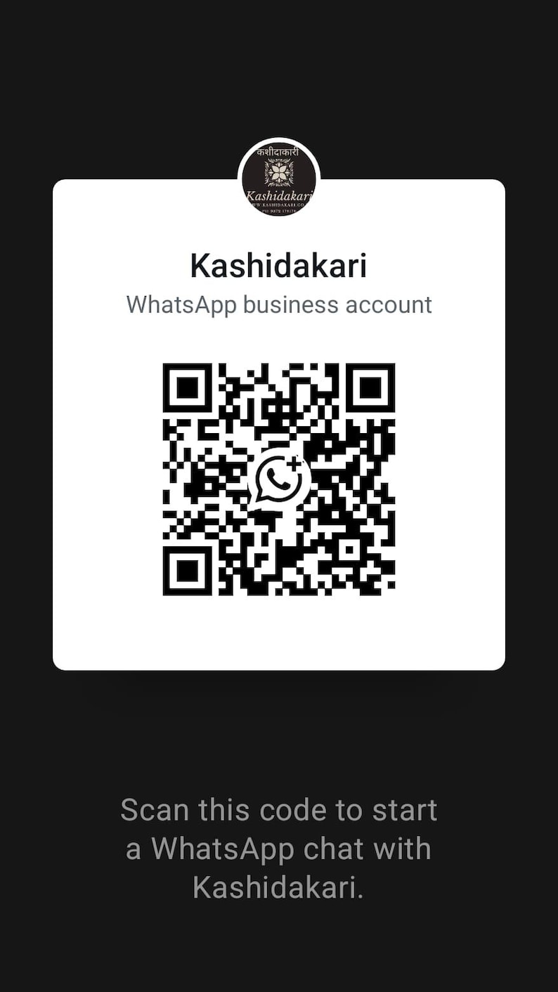 May include: A white square card featuring a black circular logo with the text Kashidakari at the top, followed by the text Kashidakari WhatsApp business account, a large black and white QR code, and the text Scan this code to start a WhatsApp chat.
