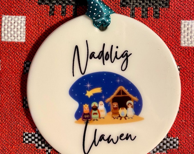 Addurn seramig i’w hongian ar goedenNadolig efo dyluniad ‘Nadolig Llawen’ ceramic hanging tree decoration