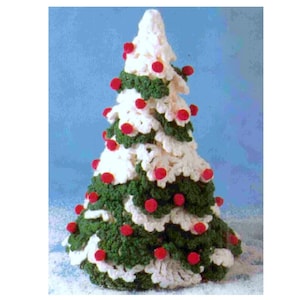 Könnte beinhalten: Ein gehäkelter Weihnachtsbaum aus weißem und grünem Garn, verziert mit roten Bommeln.