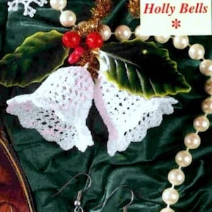 May include: Two white crocheted bells with a holly leaf and red berries on a green velvet background. The bells are hanging from a pearl necklace.